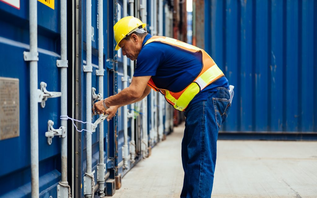 Industrial logistic worker working at overseas shipping container yard